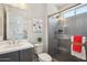 Updated bathroom featuring gray tiled shower and modern fixtures at 16949 W La Reata Ave, Goodyear, AZ 85395