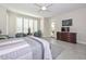 Primary bedroom featuring plantation shutters, a ceiling fan, a sitting area, and nice decor at 16949 W La Reata Ave, Goodyear, AZ 85395