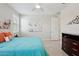 Cozy bedroom with tiled floors, neutral walls, and a ceiling fan at 16949 W La Reata Ave, Goodyear, AZ 85395