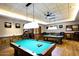 Spacious billiards room with pool tables, overhead lighting, and comfortable seating for game enthusiasts at 16949 W La Reata Ave, Goodyear, AZ 85395