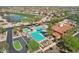 Aerial view of a community pool complex, highlighting multiple pools, lounge areas, and lush landscaping at 16949 W La Reata Ave, Goodyear, AZ 85395