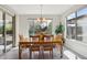 Bright dining room featuring wood table set, chandelier, tile flooring and natural light from large window views at 16949 W La Reata Ave, Goodyear, AZ 85395