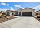 Inviting single-story home featuring desert landscaping and a spacious driveway, offering curb appeal at 16949 W La Reata Ave, Goodyear, AZ 85395