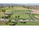 Picturesque aerial view of a beautifully designed golf course with golfers, sand traps and golf carts at 16949 W La Reata Ave, Goodyear, AZ 85395