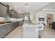 Open-concept kitchen with gray cabinets, center island, granite countertops, and stainless steel appliances at 16949 W La Reata Ave, Goodyear, AZ 85395