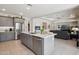 Bright and airy kitchen with stainless steel appliances, gray cabinets, and a central island at 16949 W La Reata Ave, Goodyear, AZ 85395