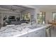 A kitchen island featuring granite countertops and stainless steel sink is perfect for food preparation at 16949 W La Reata Ave, Goodyear, AZ 85395