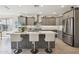Updated kitchen with gray cabinets, modern tile backsplash, stainless appliances and central island at 16949 W La Reata Ave, Goodyear, AZ 85395