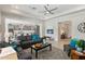 Bright and airy living room open to kitchen, with contemporary furnishings and tile flooring at 16949 W La Reata Ave, Goodyear, AZ 85395