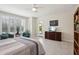 Bright main bedroom features tile floor, plantation shutters, ceiling fan and outside access at 16949 W La Reata Ave, Goodyear, AZ 85395