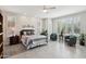Bright main bedroom with tile floor, plantation shutters, ceiling fan and sitting area at 16949 W La Reata Ave, Goodyear, AZ 85395