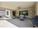 Outdoor covered patio with ceiling fan, seating and an outdoor grill at 16949 W La Reata Ave, Goodyear, AZ 85395