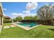 Backyard swimming pool with lush landscaping and lounge chairs at 16949 W La Reata Ave, Goodyear, AZ 85395