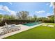 Backyard pool featuring lounge chairs, patio, and desert landscaping at 16949 W La Reata Ave, Goodyear, AZ 85395