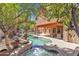 Spacious backyard featuring a pool, spa, fountain, and covered patio, creating a perfect outdoor retreat for relaxation at 20709 N 59Th Dr, Glendale, AZ 85308