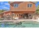 Inviting backyard pool featuring an outdoor kitchen and cozy covered patio seating area at 20709 N 59Th Dr, Glendale, AZ 85308