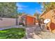 Backyard featuring a utility building, manicured landscaping, and a charming stone pathway at 20709 N 59Th Dr, Glendale, AZ 85308