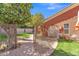 Cozy backyard featuring a decorative tree, manicured garden, and a charming patio with seating at 20709 N 59Th Dr, Glendale, AZ 85308