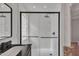 Contemporary bathroom featuring a glass-enclosed shower with black hardware and clean design at 20709 N 59Th Dr, Glendale, AZ 85308