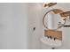 Charming powder room features pedestal sink and round mirror at 20709 N 59Th Dr, Glendale, AZ 85308
