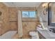 Well-lit bathroom featuring decorative tile work and a shower-tub combo at 20709 N 59Th Dr, Glendale, AZ 85308