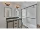Updated bathroom with a double sink vanity, modern mirrors, and frameless glass shower at 20709 N 59Th Dr, Glendale, AZ 85308