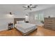 Well-furnished bedroom featuring wood floors, a modern bed, and updated lighting fixtures at 20709 N 59Th Dr, Glendale, AZ 85308