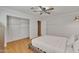 Bedroom featuring wood floors, ceiling fan, and a view into a room with brickwork at 20709 N 59Th Dr, Glendale, AZ 85308