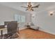 Spacious bedroom with wood floors, a ceiling fan, and a corner desk area at 20709 N 59Th Dr, Glendale, AZ 85308