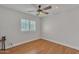 Bright bedroom featuring wood floors, a ceiling fan, and a window with shutter shades at 20709 N 59Th Dr, Glendale, AZ 85308