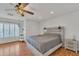 Comfortable bedroom features a ceiling fan, natural light, and wood-look floors at 20709 N 59Th Dr, Glendale, AZ 85308