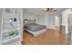 Well-lit bedroom with wood-look floors, ladder shelf, and a modern ceiling fan at 20709 N 59Th Dr, Glendale, AZ 85308
