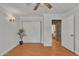 Bedroom with wood floors, closet with sliding doors, and doorway into a room with stonework at 20709 N 59Th Dr, Glendale, AZ 85308