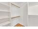 Organized walk-in closet with built-in shelves and hanging rods, maximizing storage space at 20709 N 59Th Dr, Glendale, AZ 85308