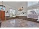 Bright dining room with stone accents, tile floors, and a decorative chandelier at 20709 N 59Th Dr, Glendale, AZ 85308