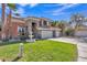 Inviting two-story home showcasing a spacious driveway, three car garage, stone accents and lush green lawn at 20709 N 59Th Dr, Glendale, AZ 85308