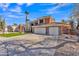 Inviting two-story home showcasing a spacious driveway, three car garage, stone accents and lush green lawn at 20709 N 59Th Dr, Glendale, AZ 85308