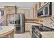 Charming kitchen features stainless steel appliances and stone accents at 20709 N 59Th Dr, Glendale, AZ 85308