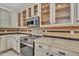 Close up of kitchen with white cabinets, granite countertops, stainless steel appliances, and mosaic backsplash at 20709 N 59Th Dr, Glendale, AZ 85308