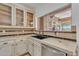 Kitchen area showcasing custom cabinets, counter tops, modern sink fixtures, and stone archways at 20709 N 59Th Dr, Glendale, AZ 85308