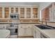 Well-appointed kitchen with stainless steel appliances, updated cabinets, sink below window, and tile backsplash at 20709 N 59Th Dr, Glendale, AZ 85308