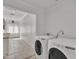 Well-lit laundry room featuring modern washer and dryer units at 20709 N 59Th Dr, Glendale, AZ 85308