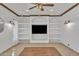 Spacious living room with custom built-ins, wood floors, recessed lighting, and elegant ceiling fan at 20709 N 59Th Dr, Glendale, AZ 85308