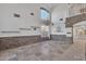 Open concept living room with vaulted ceilings, stone accent wall and travertine flooring at 20709 N 59Th Dr, Glendale, AZ 85308