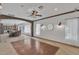 Open living room with wood floor, stone archway, recessed lighting, and large windows for natural light at 20709 N 59Th Dr, Glendale, AZ 85308
