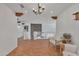 Bright living room showcasing hardwood floors, exposed wood beams, and stone accent wall at 20709 N 59Th Dr, Glendale, AZ 85308
