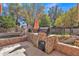 Outdoor kitchen featuring a stone barbecue and poolside slide, perfect for enjoying outdoor cooking and fun at 20709 N 59Th Dr, Glendale, AZ 85308