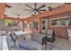 Cozy covered patio with stone accents and ceiling fans, creating an inviting outdoor living area with comfortable seating at 20709 N 59Th Dr, Glendale, AZ 85308