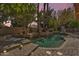 Backyard oasis with a pool, spa, and charming fountain surrounded by mature trees and serene landscaping at 20709 N 59Th Dr, Glendale, AZ 85308