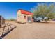 Exterior view of a small barn with double doors and a red roof with landscaping at 226 N 96Th St, Mesa, AZ 85207